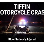 Fostoria News Motorcycle crash scene with police lights and damaged bike at night.